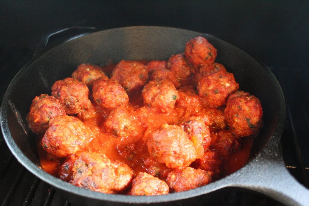 smoked meatballs in pan with tomato sauce