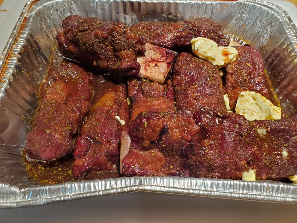 ribs in pan in braising liquid