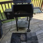 How to Clean a Pit Boss Pellet Grill (Plus a Maintenance Schedule You Can Print) Pit Boss pellet grill opened up with grates and flame broiler removed for cleaning