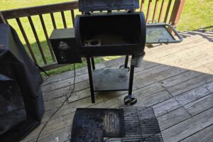 Pit Boss pellet grill opened up with grates and flame broiler removed for cleaning
