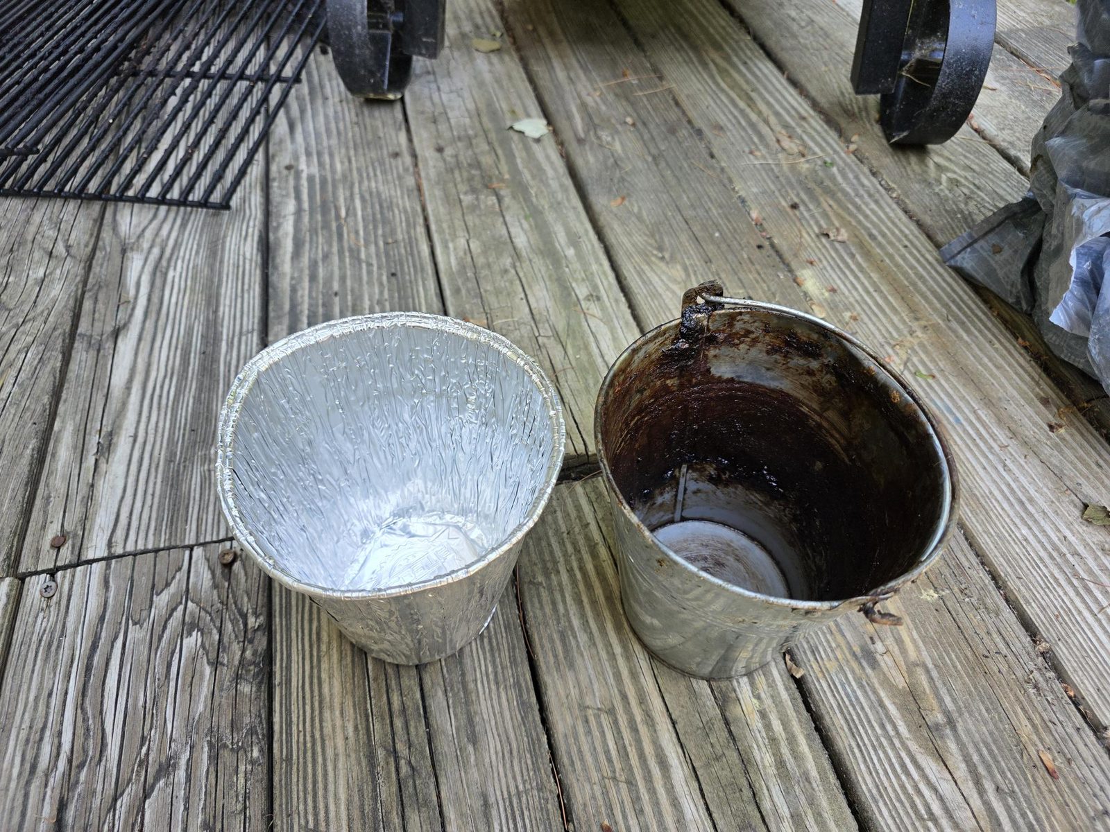 Fresh foil grease bucket liner next to a grease coated Pit Boss bucket