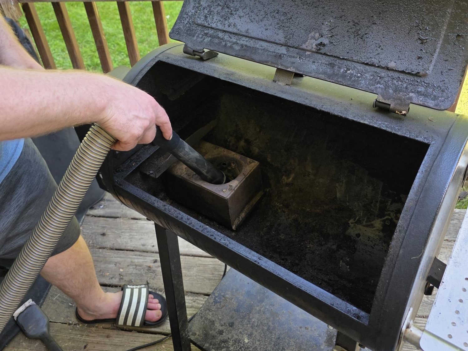 Vacuuming ash out of a Pit Boss burn pot with a shop vac