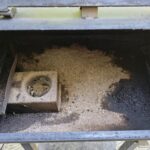 Inside a Pit Boss barrel showing ash buildup around the burn pot