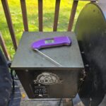 Best BBQ Thermometers for Smoking and Grilling (What I Actually Use) ThermoWorks Thermapen ONE instant-read thermometer sitting on a Pit Boss pellet grill hopper